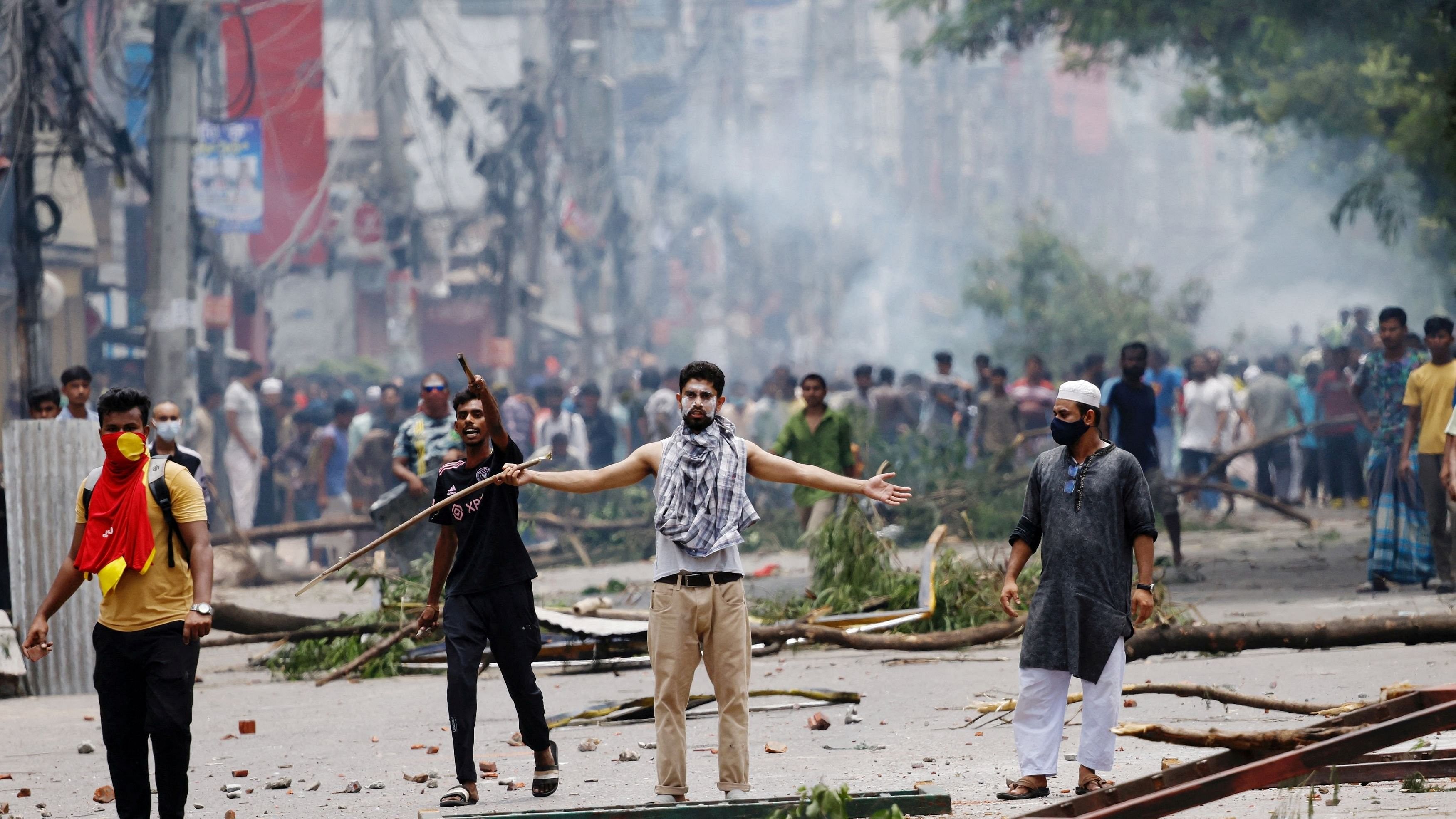 <div class="paragraphs"><p>A demonstrator gestures as protesters clash with Border Guard Bangladesh  and the police outside the state-owned Bangladesh Television as violence erupts across the country after anti-quota protests by students, in Dhaka, Bangladesh, July 19, 2024. </p></div>