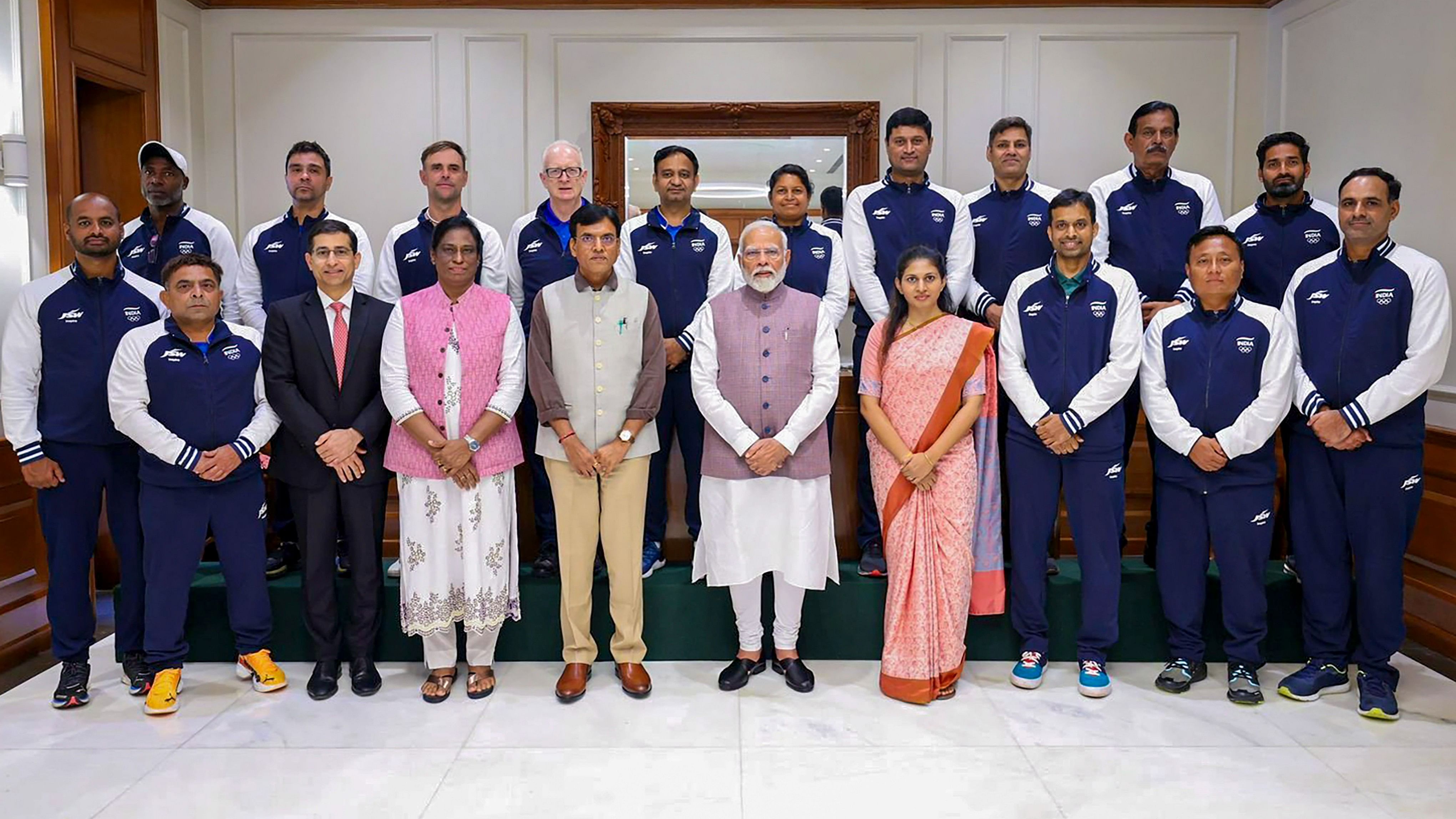 <div class="paragraphs"><p>Prime Minister Narendra Modi with Union Minister of Youth Affairs and Sports Mansukh Mandaviya and Indian Olympic Association President PT Usha poses for a group photo with the Indian contingent heading for the upcoming Paris Olympics.</p></div>