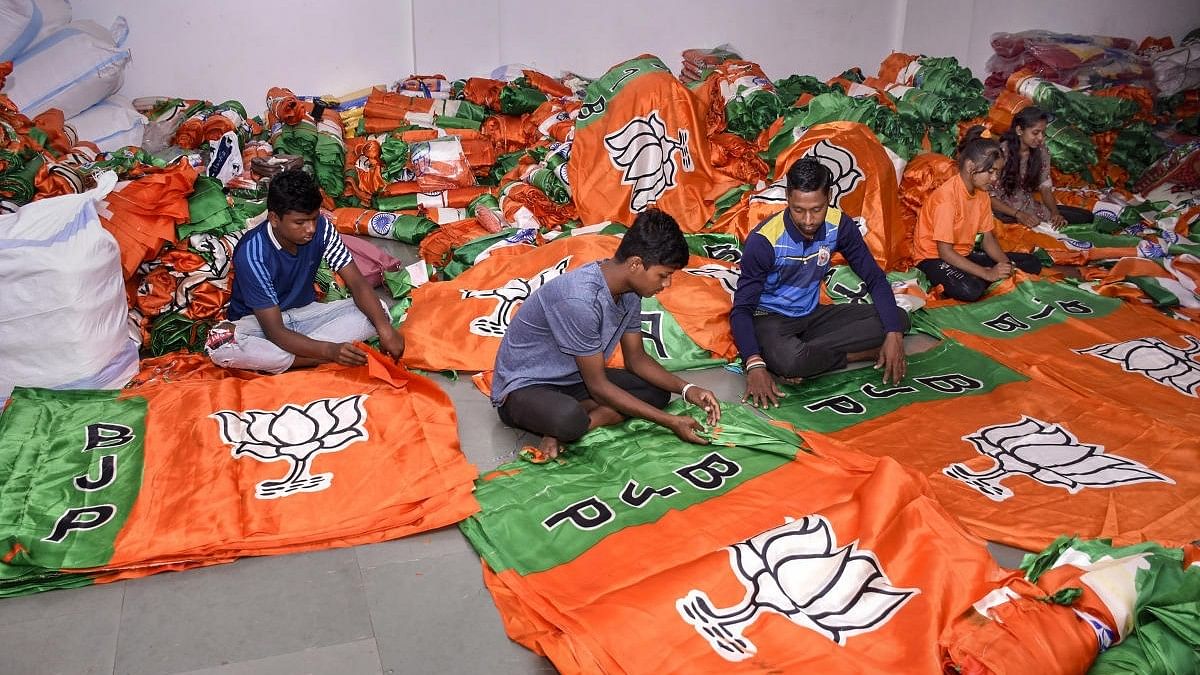 <div class="paragraphs"><p>Workers prepare BJP flags for campaigning.</p></div>