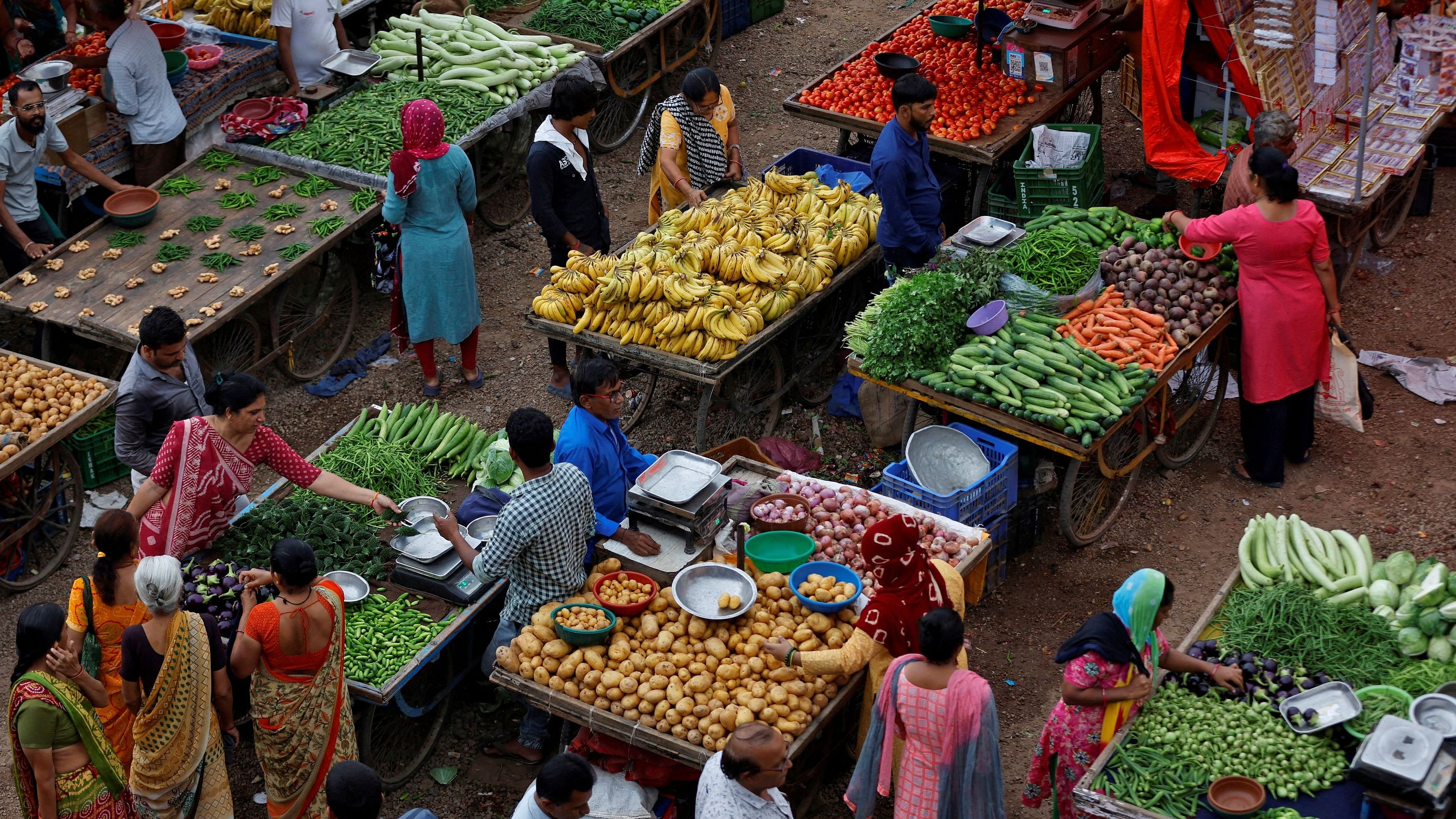 <div class="paragraphs"><p>Customers buy fruits and vegetables at an open air evening market</p></div>