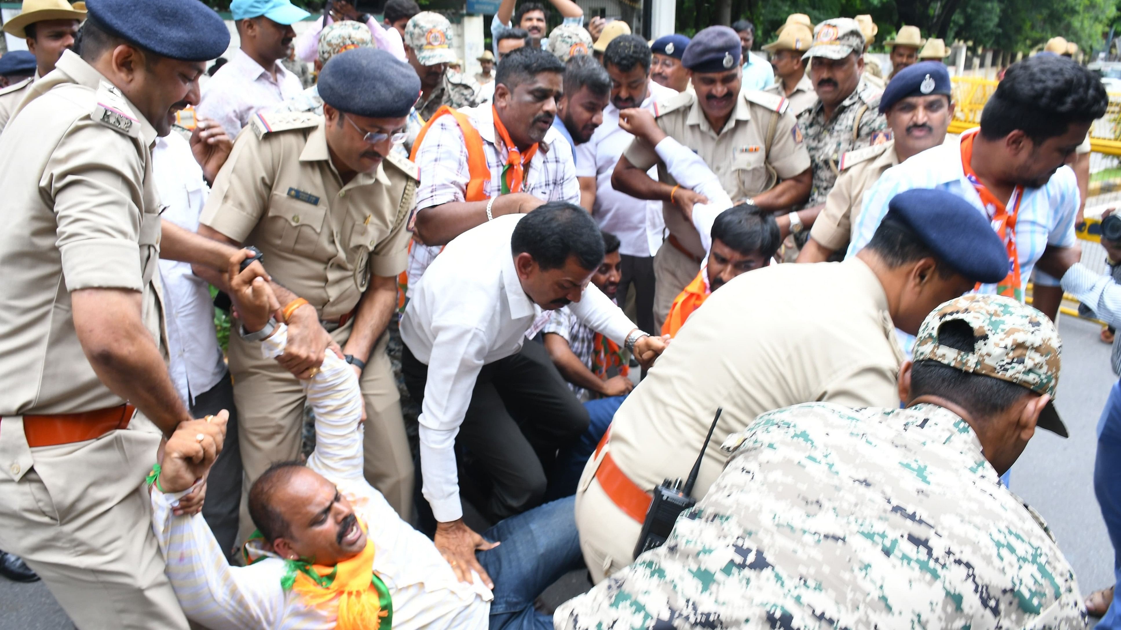 <div class="paragraphs"><p>BJP members stage a protest, against the multi-crore scam in Mysuru Urban Development Authority in Mysuru on Thursday. </p></div>