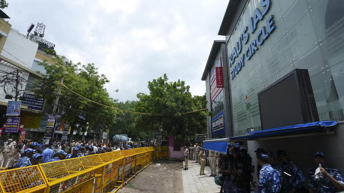 <div class="paragraphs"><p>Security personnel stand guard near a UPSC exam coaching centre after three civil services aspirants died when the basement of the coaching centre was flooded by rainwater.</p></div>