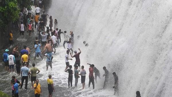 <div class="paragraphs"><p>People play in water from an overflowing lake following heavy rainfall, in Mumbai, Sunday, July 14, 2024. Representative image</p></div>