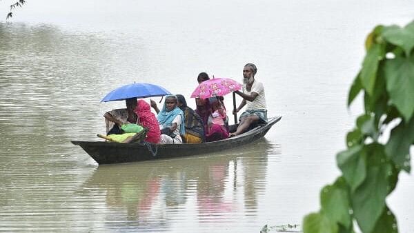 <div class="paragraphs"><p>Villagers move to a safer place from a flood affected area, in Morigaon district, Tuesday, July 2, 2024.</p></div>