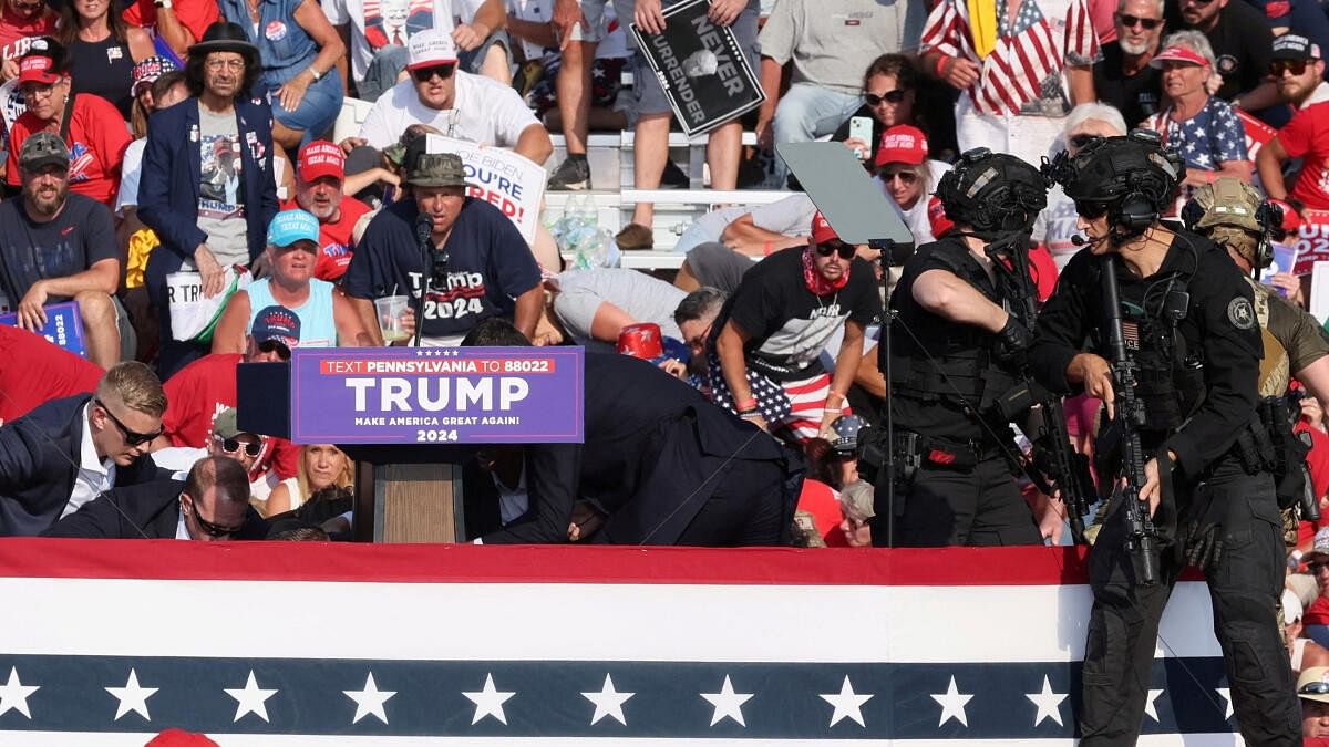 <div class="paragraphs"><p>Republican presidential candidate and former US president Donald Trump is assisted by US Secret Service personnel after gunfire rang out during a campaign rally at the Butler Farm Show in Butler, Pennsylvania, US.</p></div>