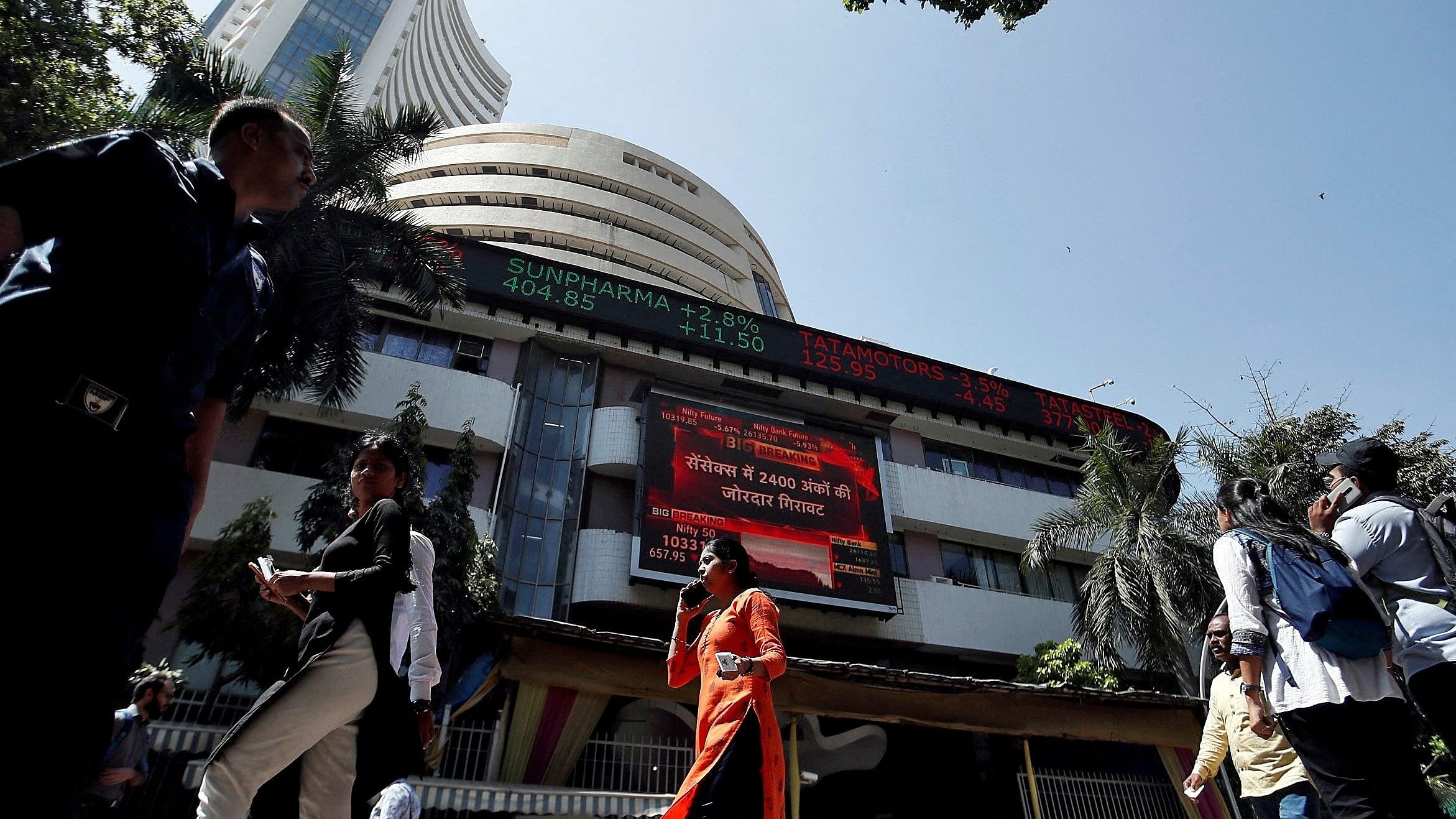 <div class="paragraphs"><p>People walk past the Bombay Stock Exchange  building in Mumbai, India, March 9, 2020.</p></div>