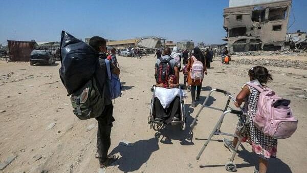 <div class="paragraphs"><p>A Palestinian woman sits on a wheelchair as she and others flee the eastern part of Khan Younis after they were ordered by Israeli army to evacuate their neighborhoods, amid Israel-Hamas conflict, in Khan Younis in the southern Gaza Strip.&nbsp;</p></div>