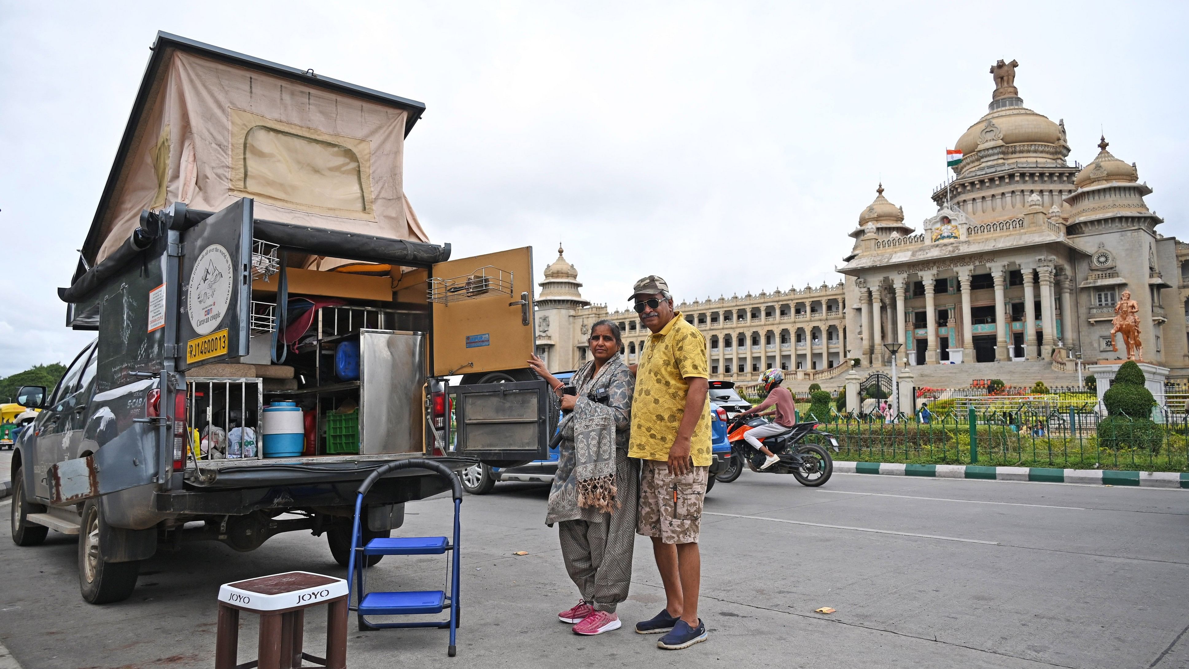 Anil and Geeta Mehta with their pickup truck in front of Vidhana Soudha in Bengaluru. 