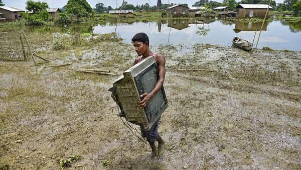 <div class="paragraphs"><p>A villager shifts his belongings from a flood affected area to a safer place, at Kaliabor in Nagaon district.&nbsp;</p></div>