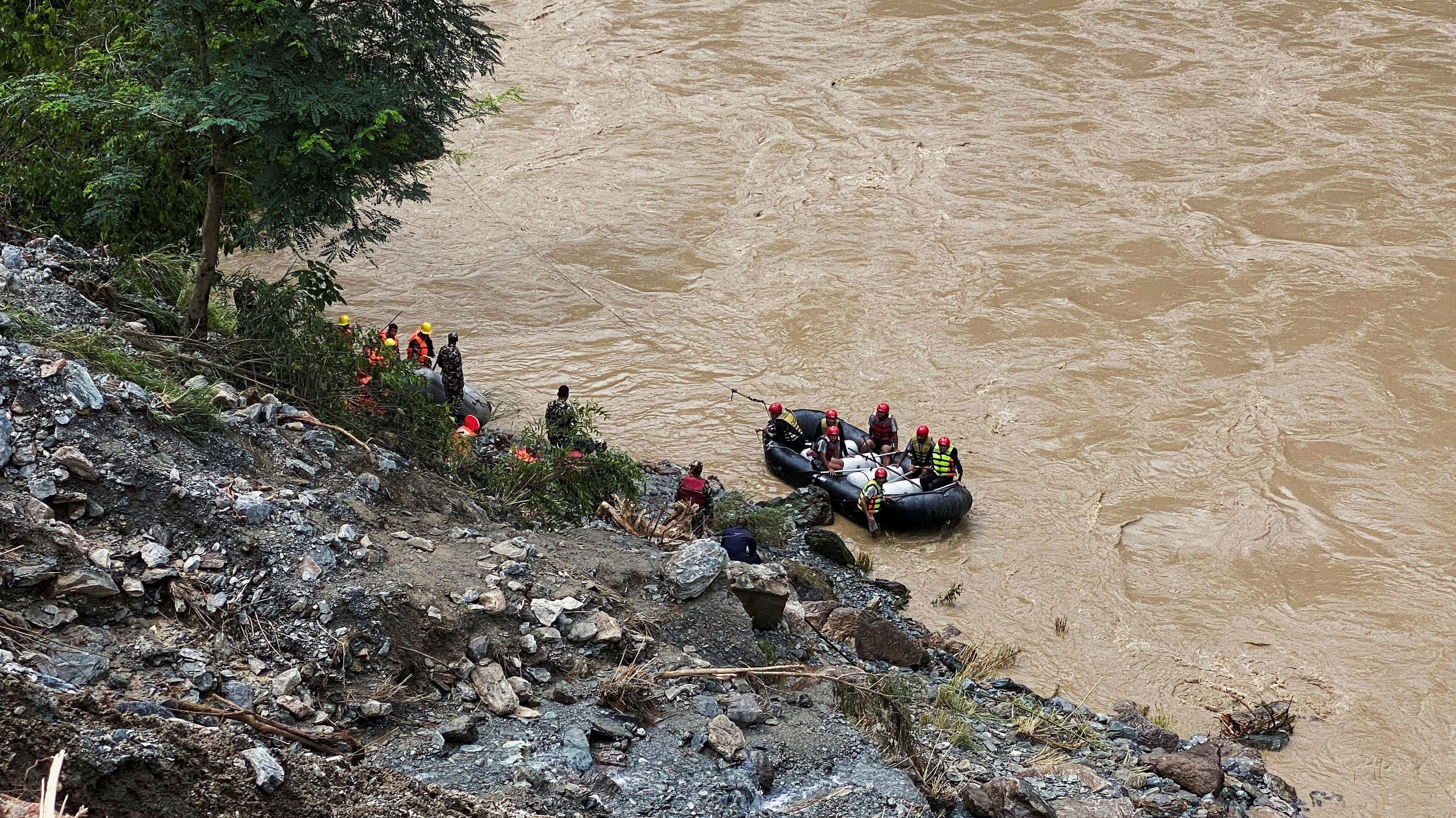 <div class="paragraphs"><p>Rescuers search for people missing after landslides swept away two buses into a swollen river in Nepal.</p></div>