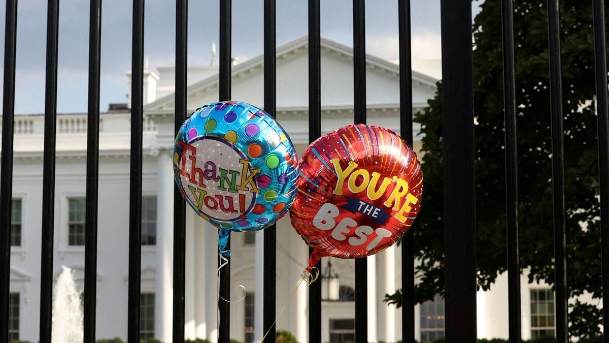 <div class="paragraphs"><p>Balloons that were tied to the fence are pictured as people gather outside the White House after US President Joe Biden announced he is stopping his bid for reelection</p></div>