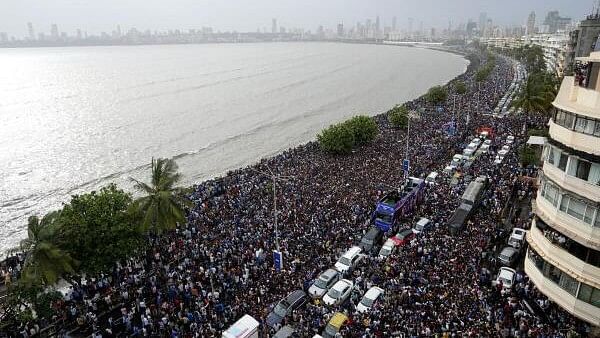 <div class="paragraphs"><p>Fans wait for the arrival of Indian cricket team members for a victory parade to celebrate winning the ICC men's T20 World Cup, along the Marine Drive in Mumbai</p></div>