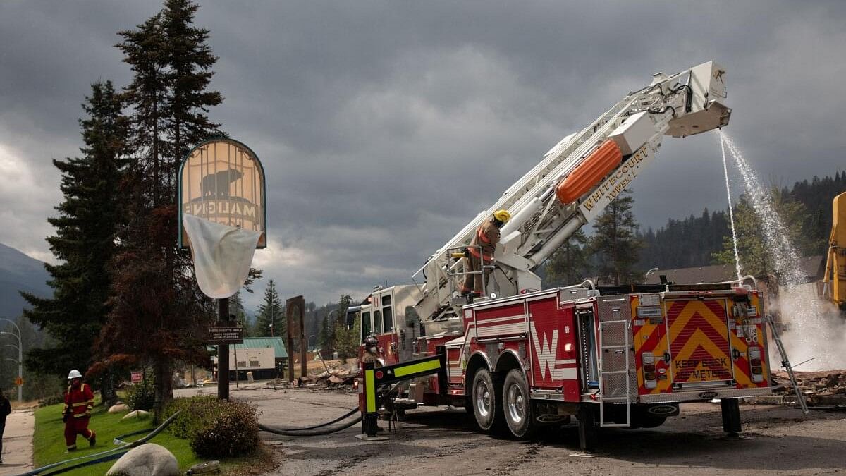 <div class="paragraphs"><p>Fire crews work to put out hotspots in the Maligne Lodge in Jasper, Alberta, Canada.</p></div>