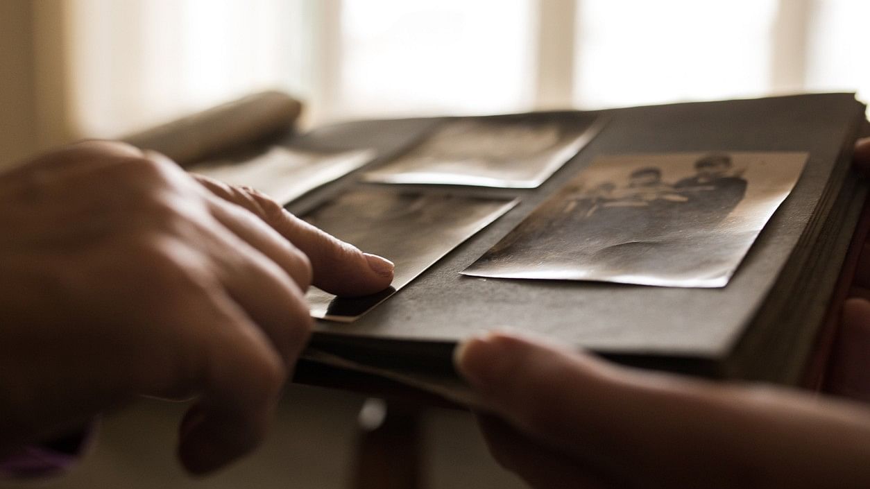 <div class="paragraphs"><p>Representative image showing a person looking up old photos.</p></div>