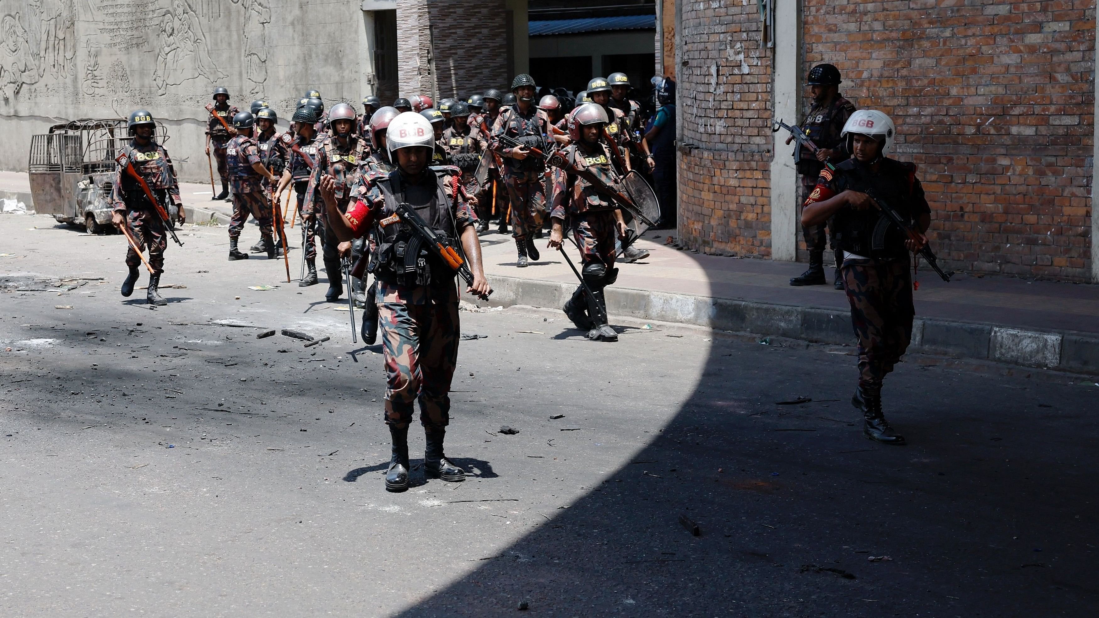 <div class="paragraphs"><p>Members of Border Guard Bangladesh  stand guard outside the state-owned Bangladesh Television as violence erupts after anti-quota protests by students, in Dhaka.</p></div>