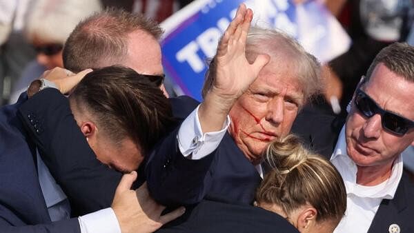 <div class="paragraphs"><p>Donald Trump escorted by his security after being shot at</p></div>