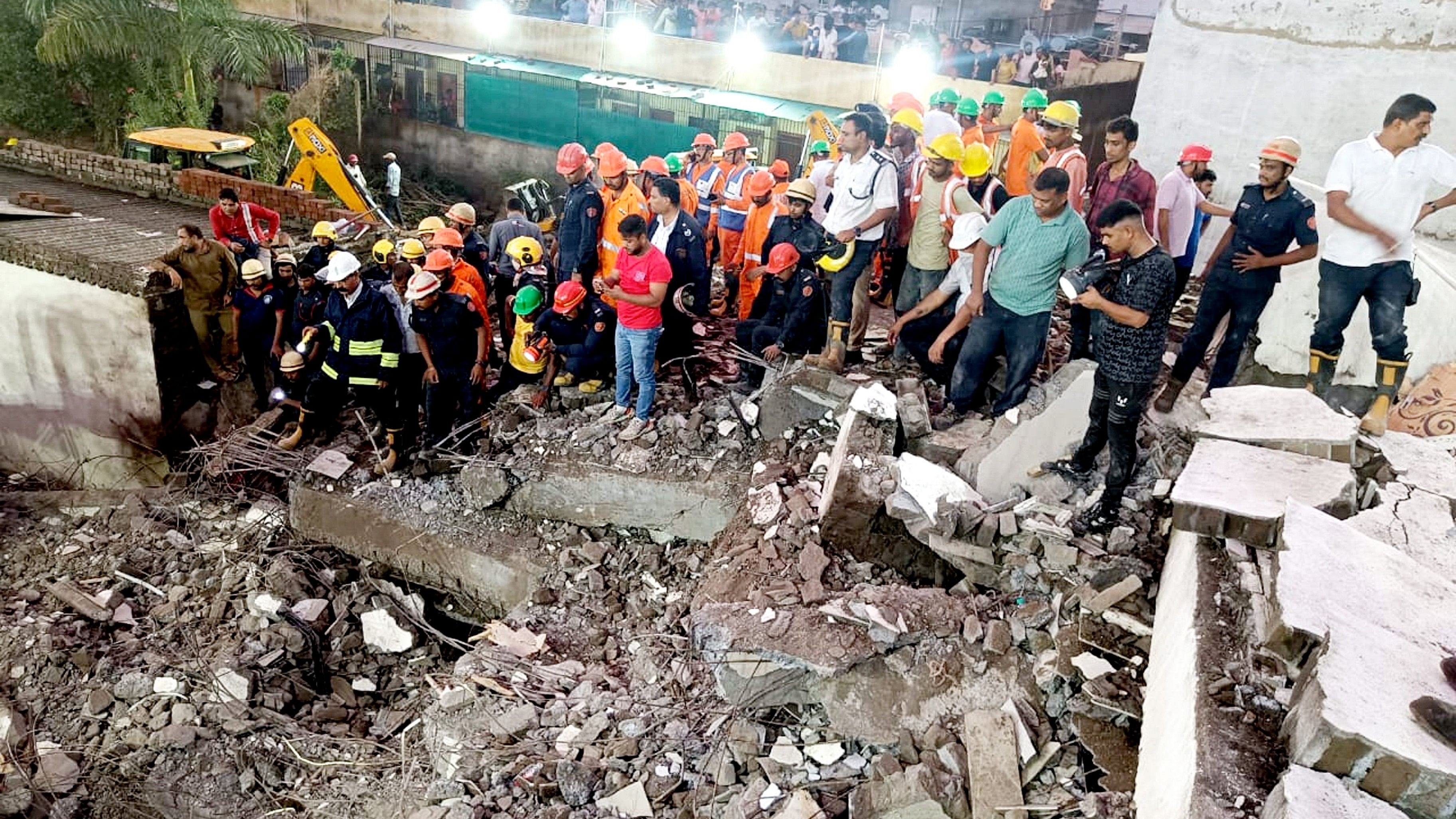 <div class="paragraphs"><p>Officials and others during a rescue operation after a building collapses, in Surat last week.</p></div>