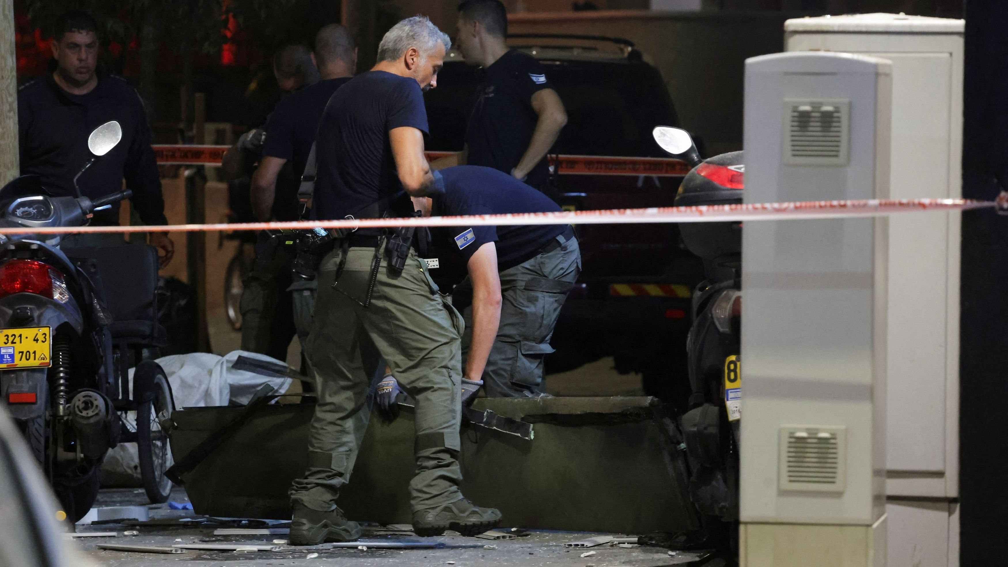 <div class="paragraphs"><p>Emergency personnel inspect debris at the site of an explosion, amid the Israel-Hamas conflict in Tel Aviv, Israel.</p></div>