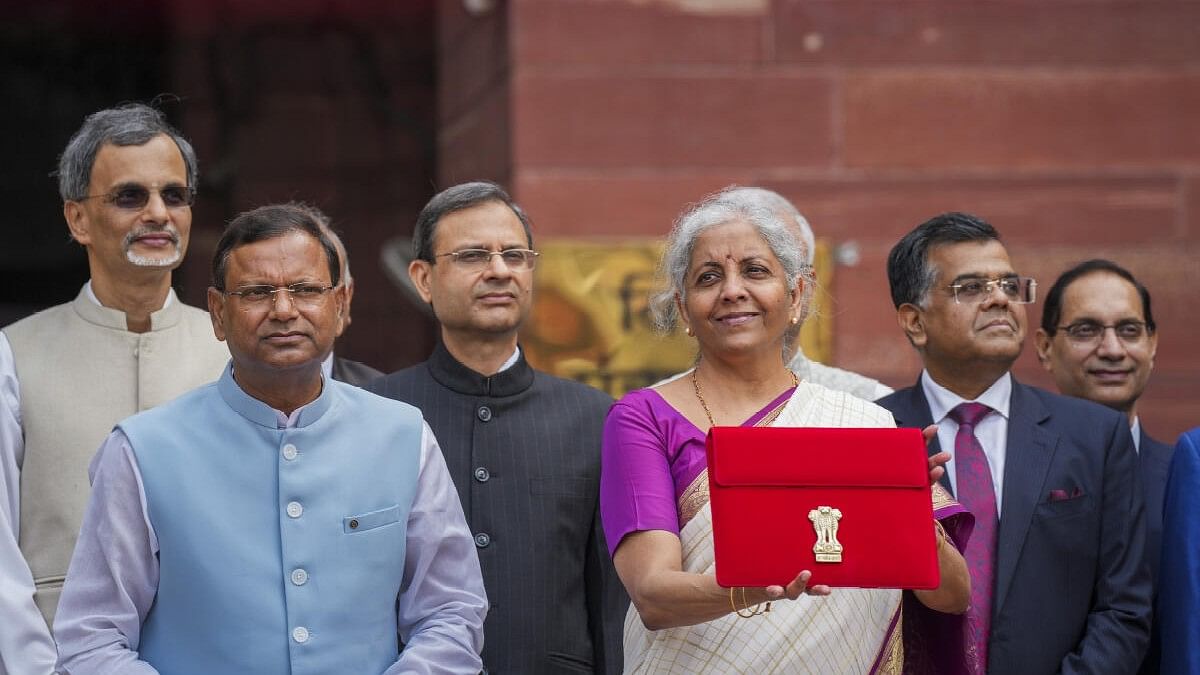 <div class="paragraphs"><p>Union Finance Minister Nirmala Sitharaman displays a red pouch carrying the Budget documents outside the Finance Ministry.</p></div>