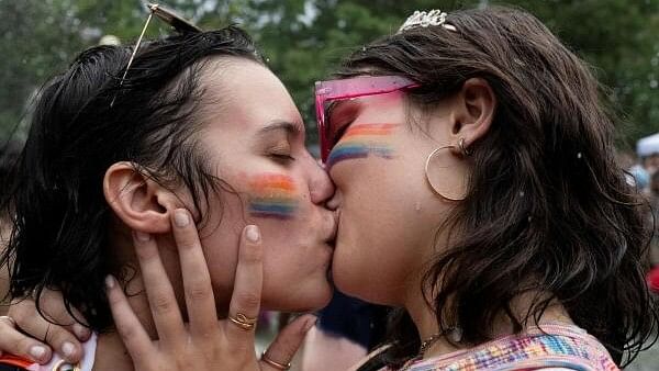 <div class="paragraphs"><p>Revelers celebrate Pride in the fountain in Washington Square Park in New York City, New York</p></div>