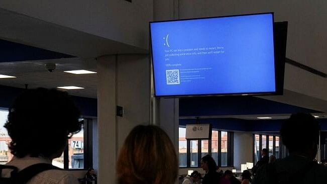 <div class="paragraphs"><p>Travelers walk past a monitor displaying a blue error screen, also known as the “Blue Screen of Death” inside Terminal C in Newark International Airport, after United Airlines and other airlines grounded flights due to a worldwide tech outage caused by an update to Crowdstrike's "Falcon Sensor" software which crashed Microsoft Windows systems, in Newark, New Jersey, US, July 19, 2024.</p></div>