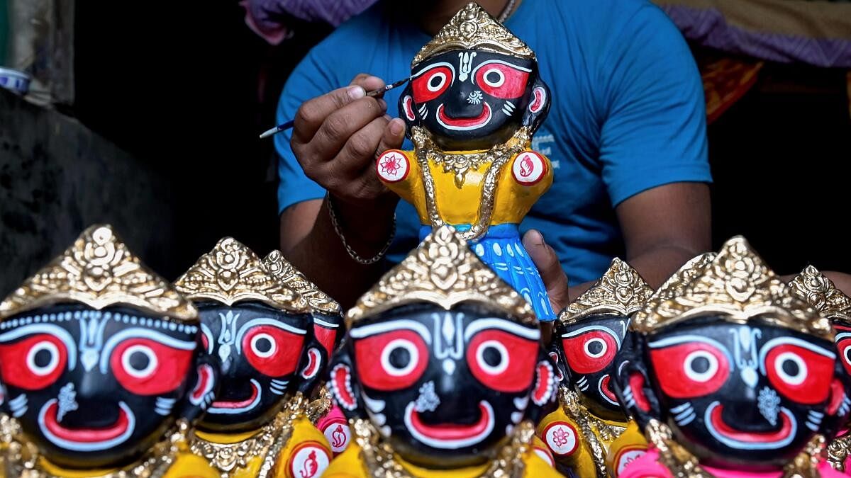 <div class="paragraphs"><p>An artist gives finishing touches to an idol of Lord Jagannath ahead of the Rath Yatra festival, in Nadia district.</p></div>