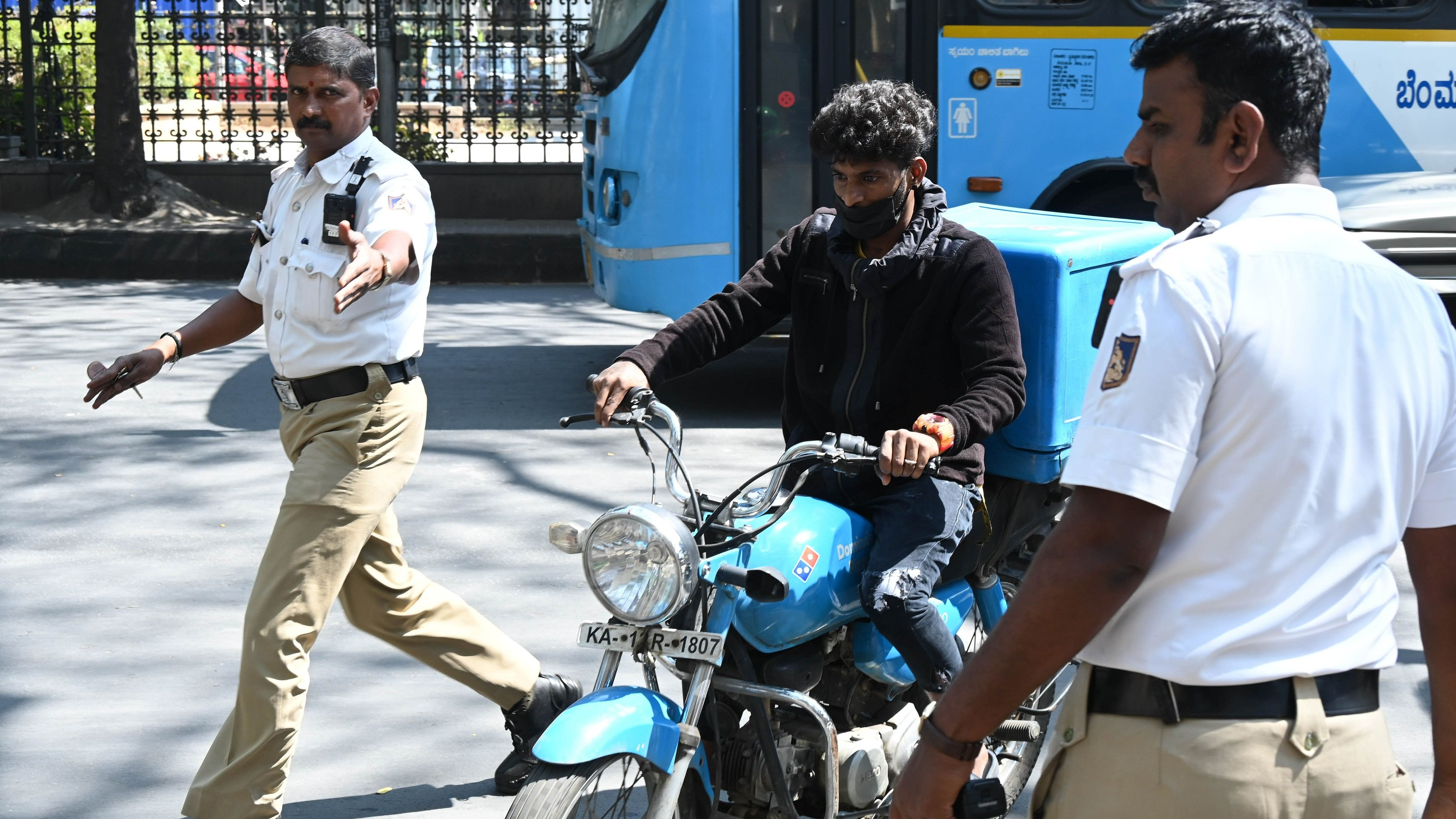 <div class="paragraphs"><p>Traffic police fine a food delivery executive for riding without a helmet. </p></div>