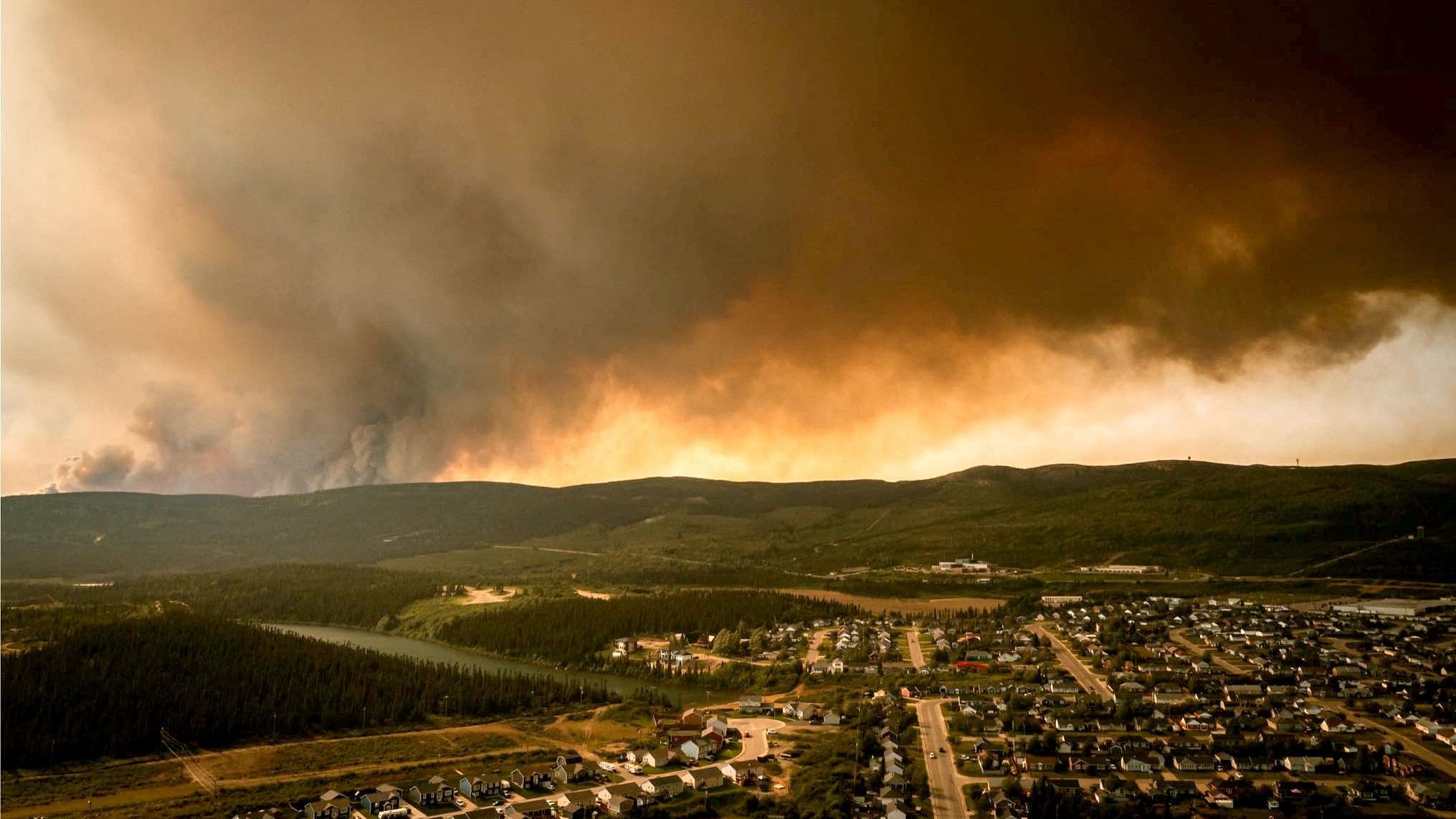 <div class="paragraphs"><p>Smoke from an encroaching wildfire is seen over homes after an evacuation was ordered in the eastern Canadian community of Labrador City.</p></div>