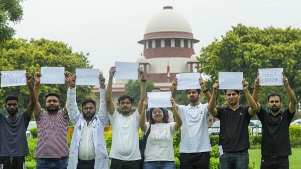 <div class="paragraphs"><p>Students display placards in the precinct of the Supreme Court during a hearing on the NEET paper leak case in New Delhi on July 18, 2024. </p></div>