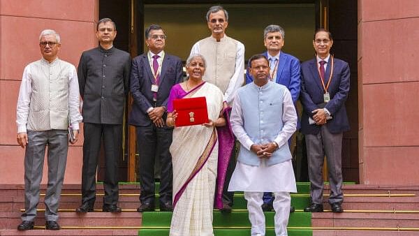 <div class="paragraphs"><p>Union Finance Minister Nirmala Sitharaman with a red pouch carrying the Budget documents at the Parliament to present the Union Budget 2024-25, in New Delhi, Tuesday, July 23, 2024. MoS Pankaj Chaudhary and Chief Economic V Anantha Nageswaran are also seen.</p></div>