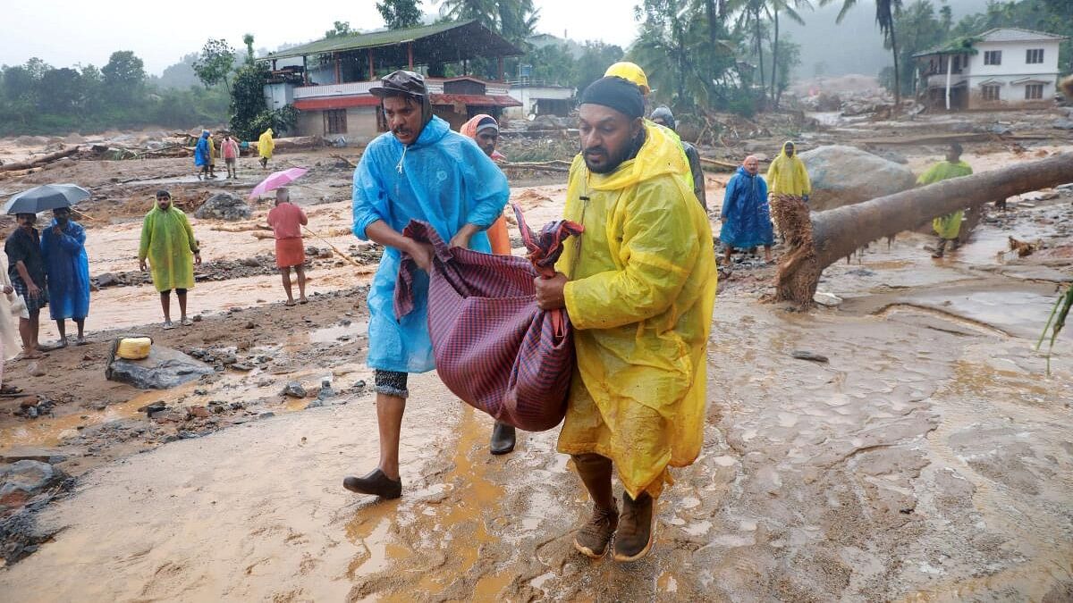 <div class="paragraphs"><p>Rescuers carry the body of a victim at the landslide site after multiple landslides in the hills, in Wayanad, in the southern state of Kerala, India, July 30, 2024.</p></div>