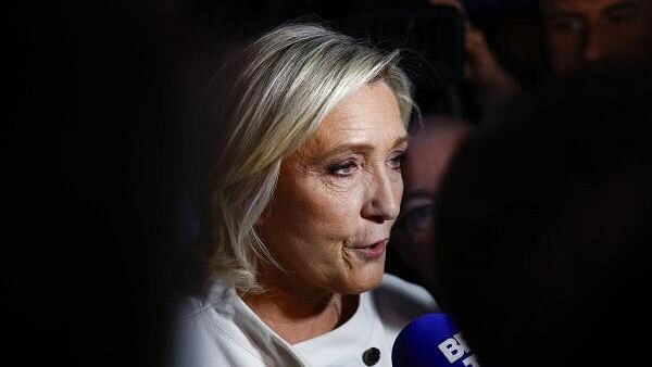 <div class="paragraphs"><p>French far-right leader Marine Le Pen talks to journalists after partial results in the second round of the early French parliamentary elections, at the French far-right Rassemblement National (National Rally - RN) party venue in Paris, France, July 7, 2024.</p></div>