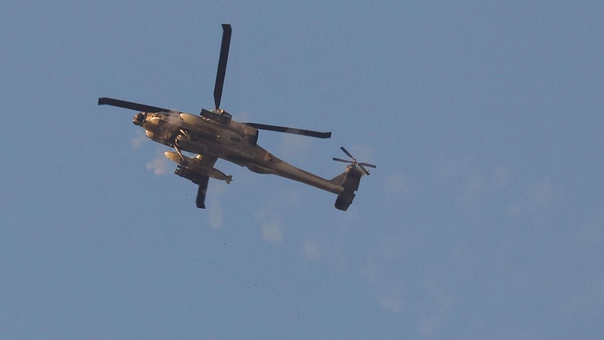 <div class="paragraphs"><p>An Israeli Apache helicopter fires its machine gun towards Gaza, as it flies near the Israel-Gaza border.</p></div>