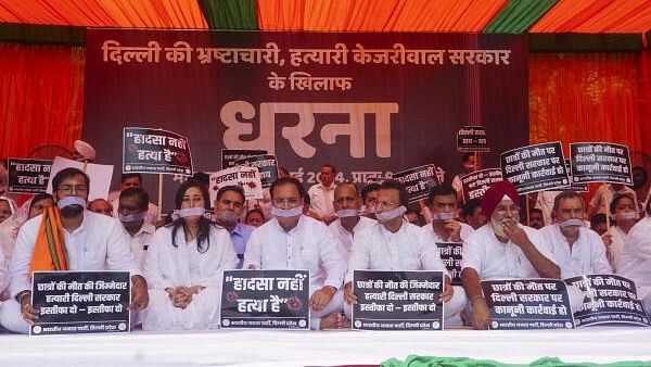 <div class="paragraphs"><p>Delhi BJP President Virendra Sachdeva with MP Bansuri Swaraj and other leaders stages a protest against the Delhi government over the death of three civil services aspirants due to drowning, at Rajghat, in New Delhi, Tuesday, July 30, 2024.</p></div>