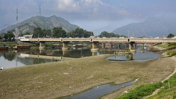 <div class="paragraphs"><p>River Jhelum, partially dried due to a long spell of dry weather and heatwave conditions, in Srinagar, Tuesday.&nbsp;</p></div>