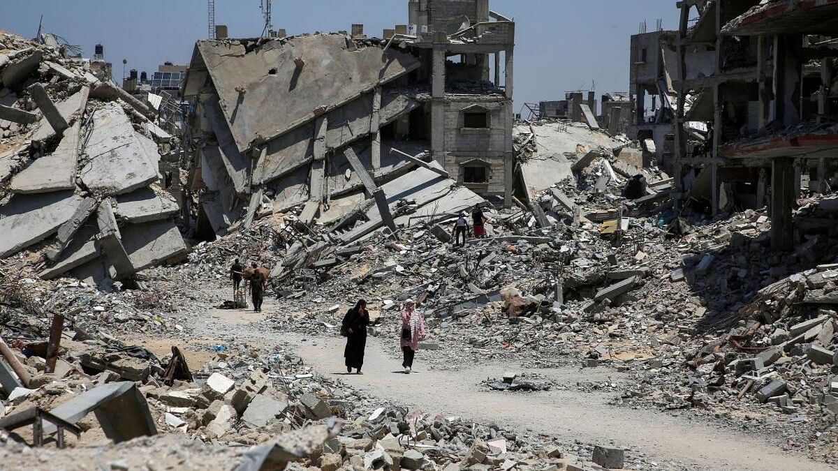 <div class="paragraphs"><p>Palestinians walk past the rubble of houses destroyed during the Israeli military offensive, amid Israel-Hamas conflict, in Khan Younis in the southern Gaza Strip on&nbsp;July 10, 2024.</p></div>