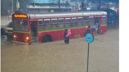 <div class="paragraphs"><p>A bus moves on a waterlogged road during monsoon rain, at Parel in Mumbai, Sunday, July 21, 2024.</p></div>