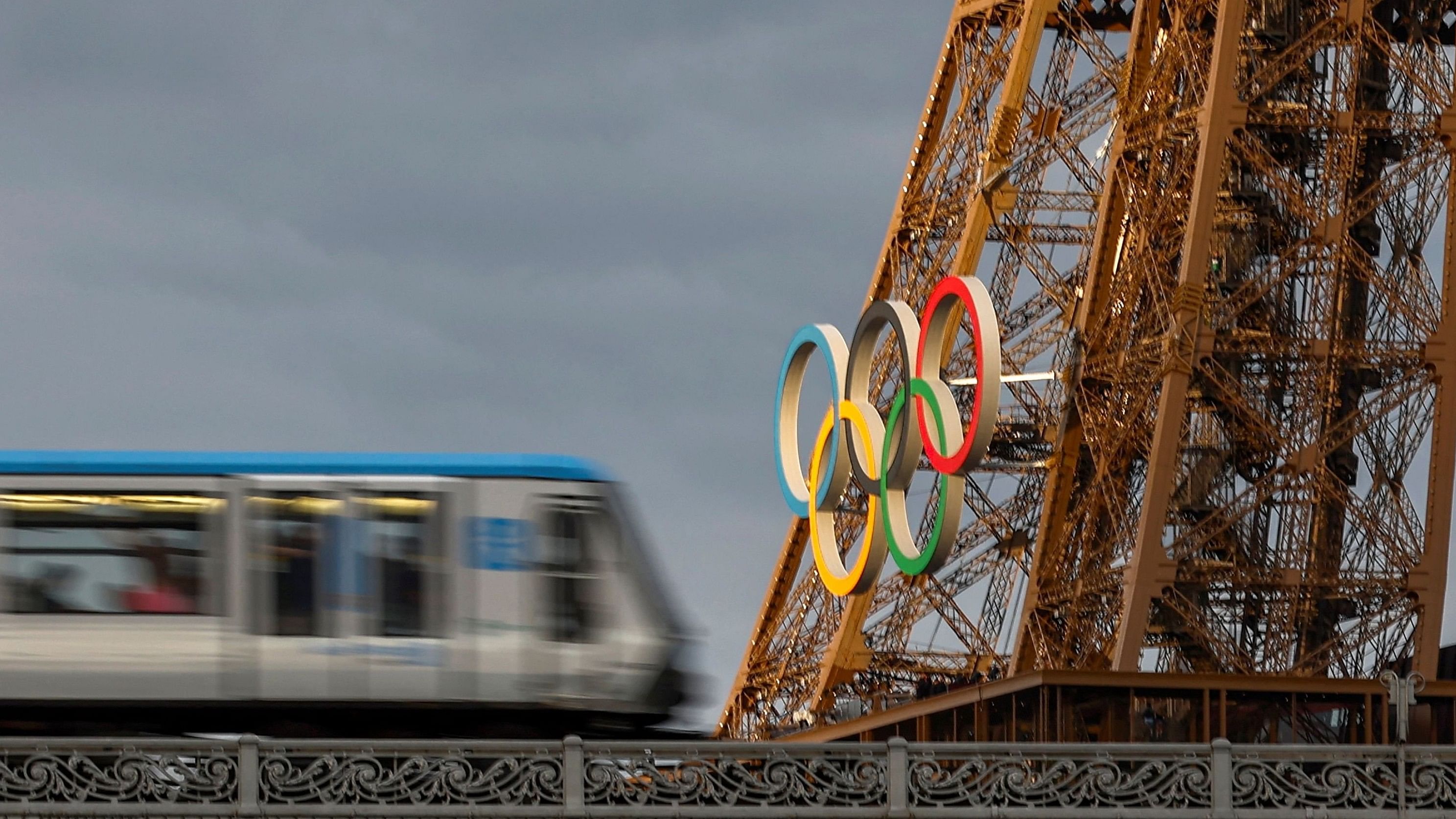 <div class="paragraphs"><p>An elevated Paris Metro RATP transport network passes over the Pont de Bir-Hakeim bridge as the Eiffel Tower with the Olympic rings are seen ahead of the Paris 2024 Olympics and Paralympics Games in Paris, France.</p></div>