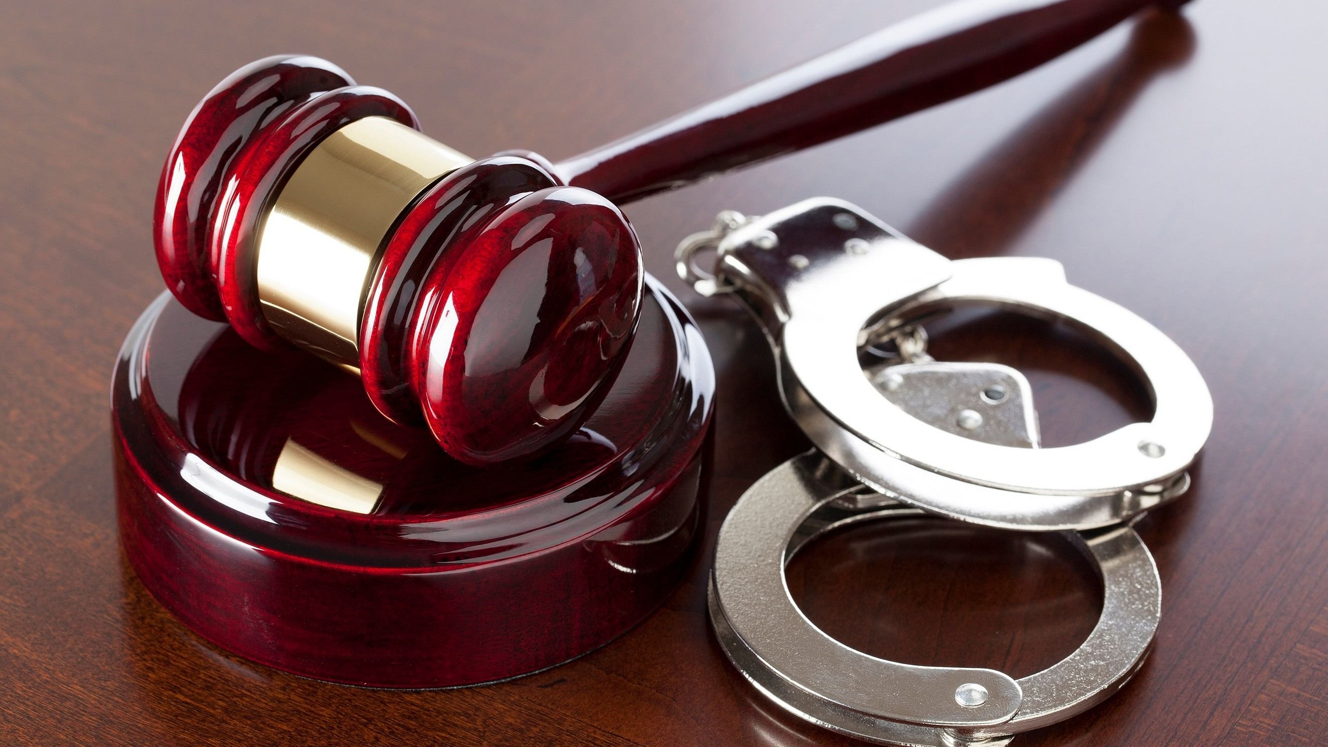 <div class="paragraphs"><p>Representative image showing a gavel and handcuffs.</p></div>