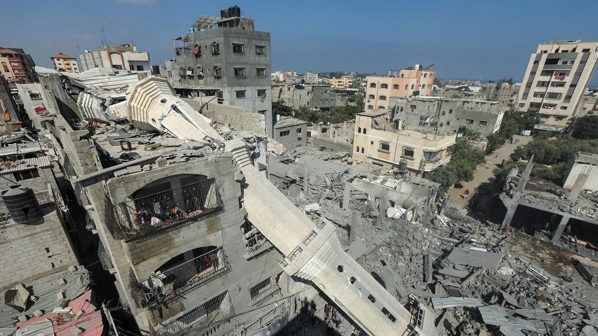 <div class="paragraphs"><p>The collapsed minaret of Abdullah Azzam mosque leans against a house after the mosque was hit by an Israeli strike, amid the Israel-Hamas conflict, in Nuseirat refugee camp in the central Gaza strip.</p></div>