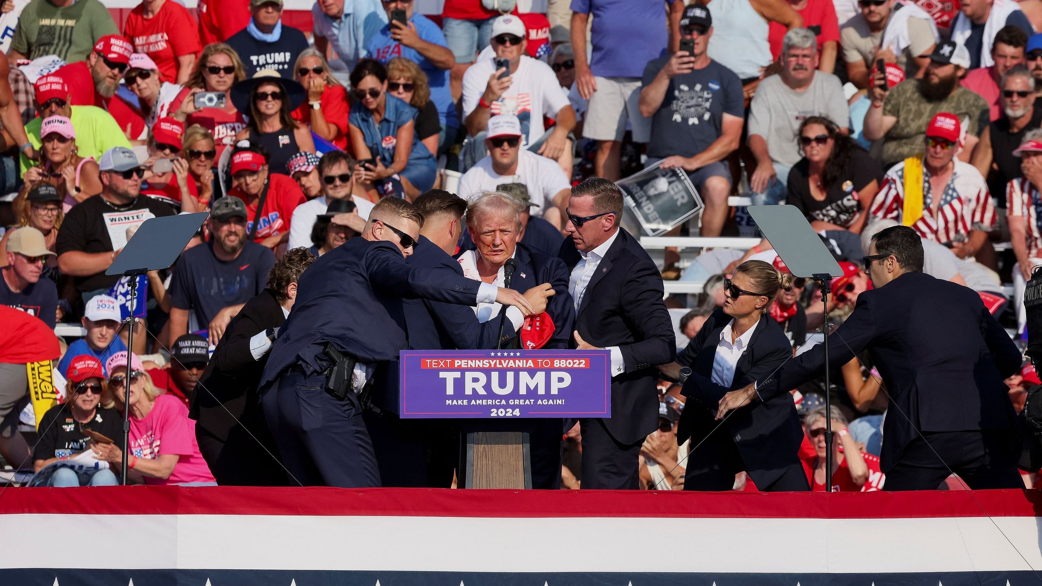 <div class="paragraphs"><p>Republican presidential candidate and former US President Donald Trump is assisted by US Secret Service personnel after he was shot in the right ear during a campaign rally at the Butler Farm Show in Butler, Pennsylvania, U.S., July 13, 2024. </p></div>