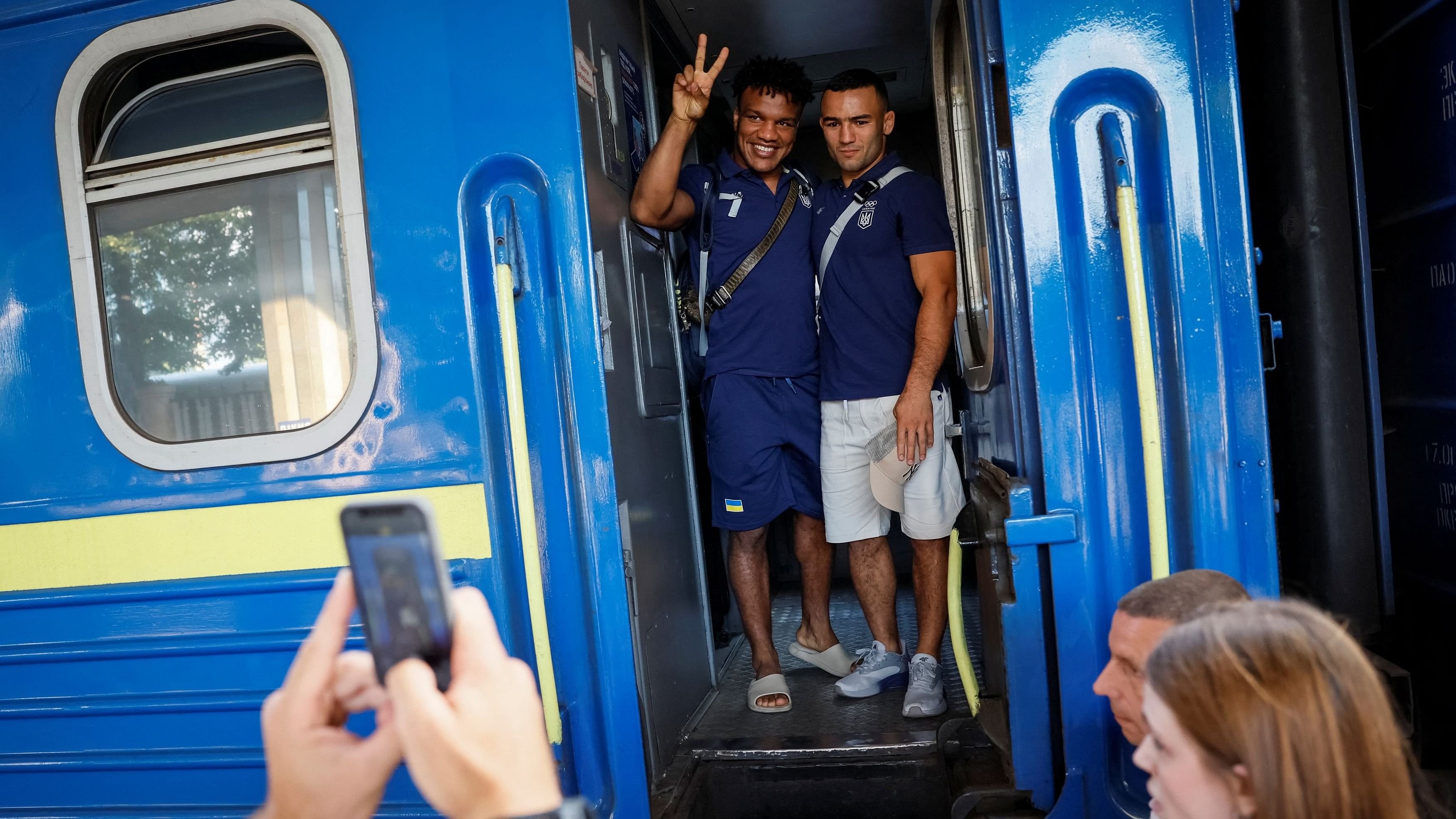 <div class="paragraphs"><p>A gold medallist of 2020 Tokyo Olympics and a member of the Ukrainian Olympic wrestling team Zhan Beleniuk and his teammate Parviz Nasibov say goodbye their friends and families as they board a train to the Paris 2024 Olympics via Poland, amid Russia's attack on Ukraine, in Kyiv, Ukraine July 23, 2024. </p></div>