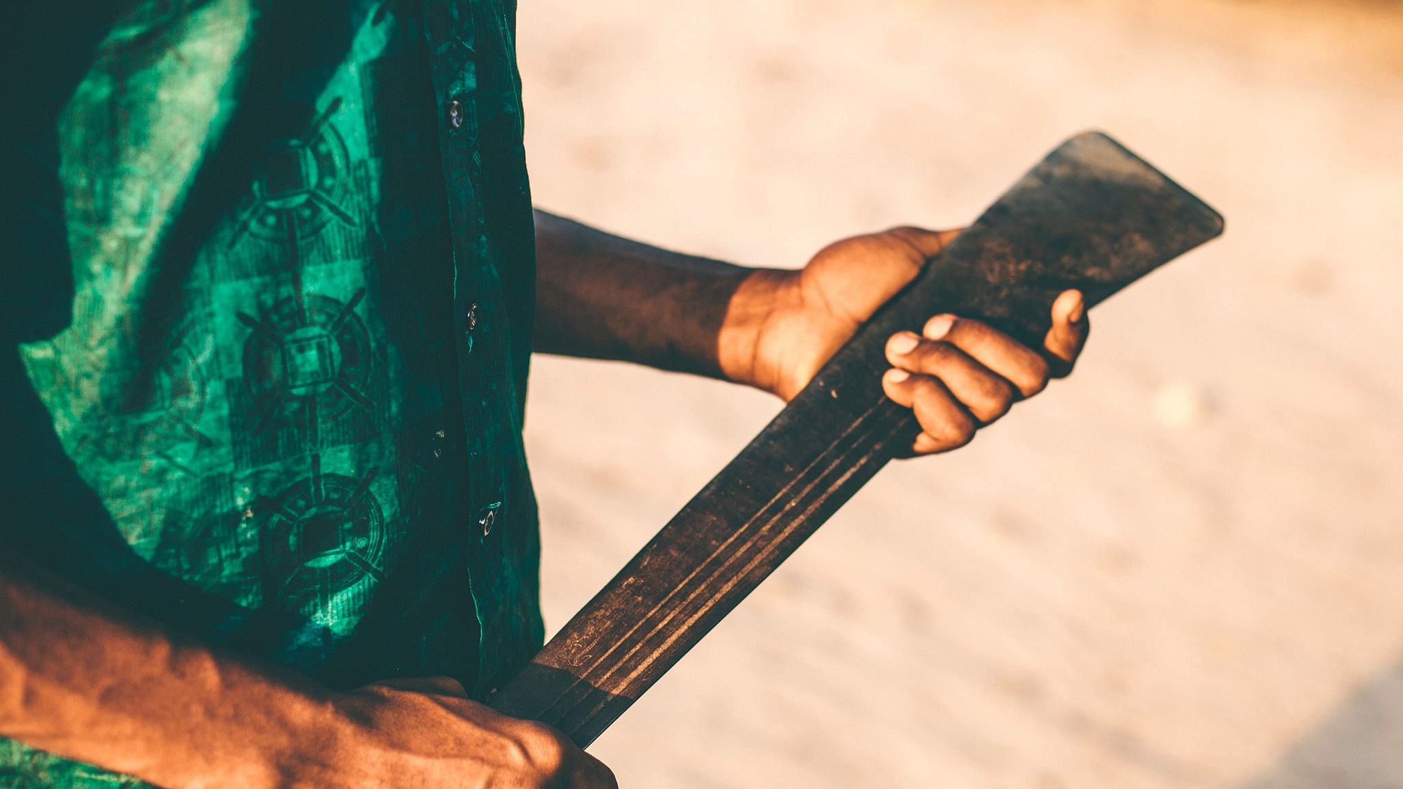 <div class="paragraphs"><p>Representative image of a man with a machete.</p></div>