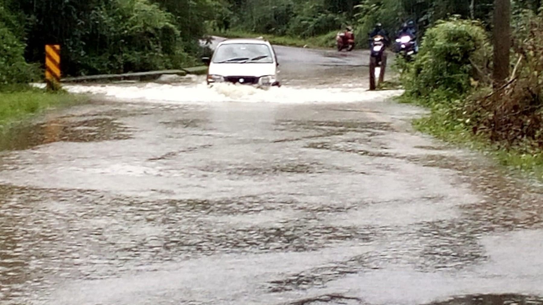 <div class="paragraphs"><p>Vehicles move in flood water in Bolibane in Hoddur village near Napoklu on Tuesday.</p></div>