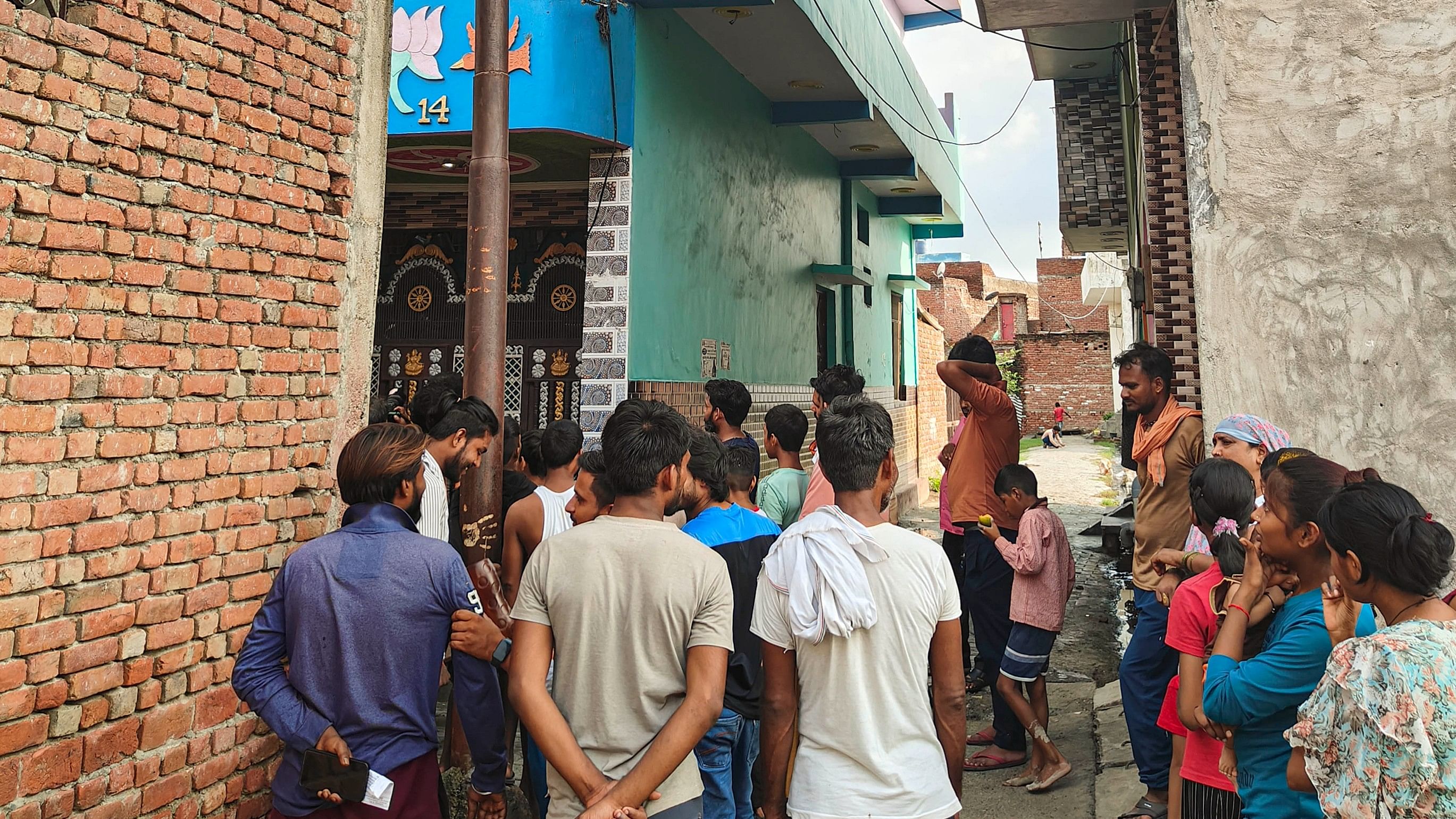 <div class="paragraphs"><p>People gather near the house of Hathras stampede key accused Devprakash Madhukar.</p></div>