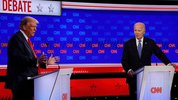 <div class="paragraphs"><p>Democrat presidential candidate U.S. President Joe Biden listens as Republican presidential candidate and former U.S. President Donald Trump speaks during their debate in Atlanta.&nbsp;</p></div>