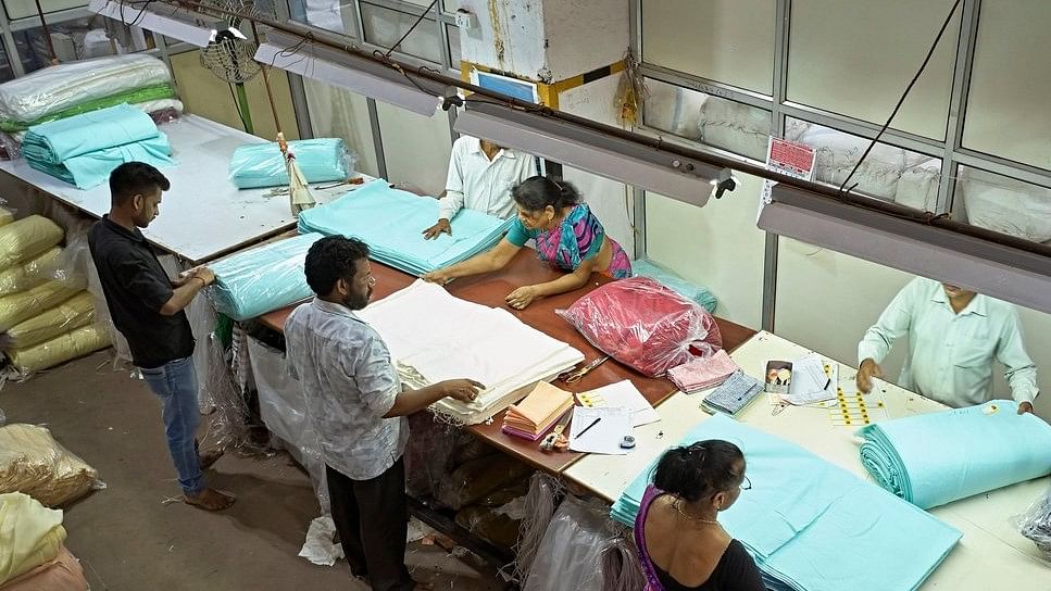 <div class="paragraphs"><p>Workers fold and wrap textiles at a factory. (Representative file image)</p></div>