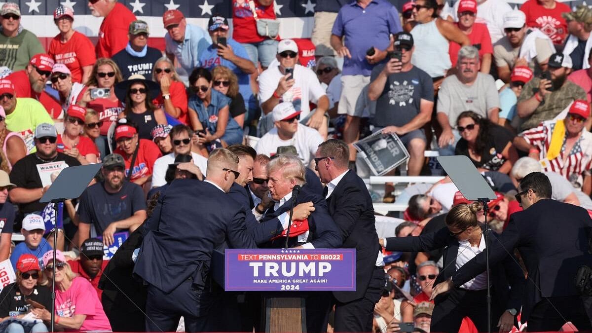 <div class="paragraphs"><p>Republican presidential candidate and former US President Donald Trump is assisted by U.S. Secret Service personnel after he was shot in the right ear during a campaign rally at the Butler Farm Show in Butler, Pennsylvania, US, July 13, 2024. </p></div>