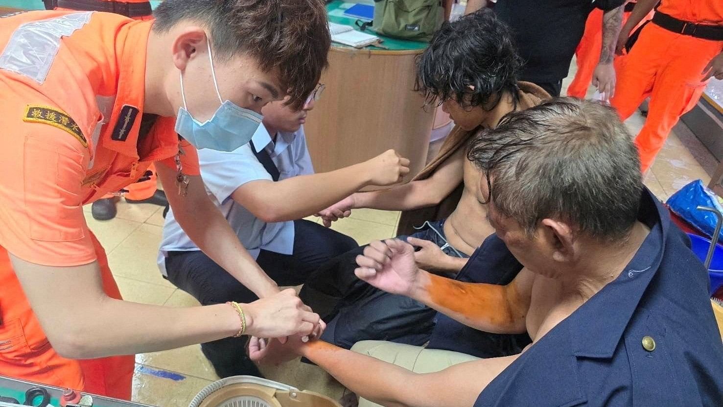 <div class="paragraphs"><p>Taiwan Coast Guard members attend to injured sailors.</p></div>