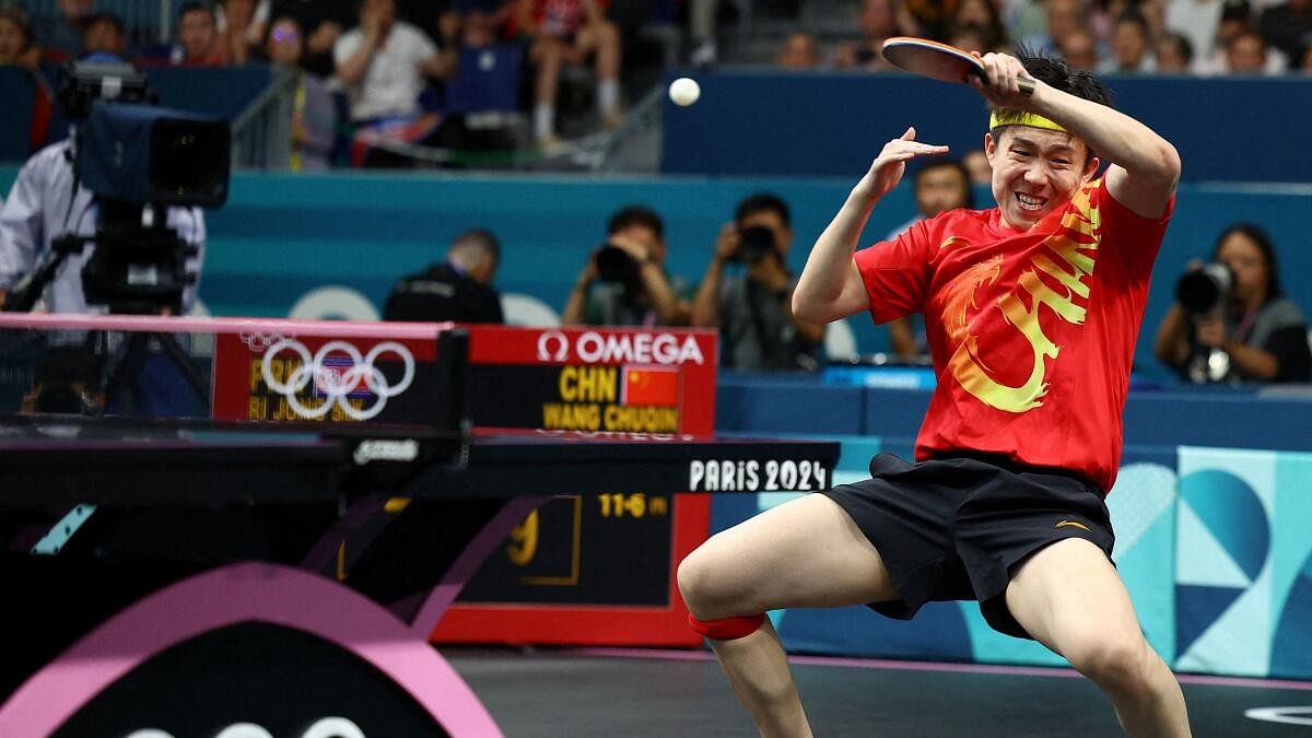 <div class="paragraphs"><p>Chuqin Wang of China in action during their match with Yingsha Sun of China against Jong Sik Ri of North Korea and Kum Yong Kim of North Korea.</p></div>